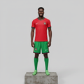 Nigerian male model wearing red and green home football kit on concrete plinth
