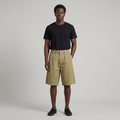 Full-body male model wearing khaki pleated shorts