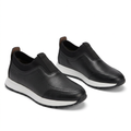 Pair of black textured white-midsole slip-on sneakers on white