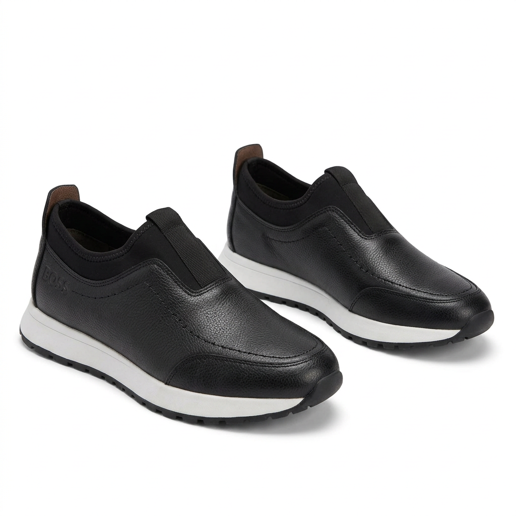 Pair of black textured white-midsole slip-on sneakers on white