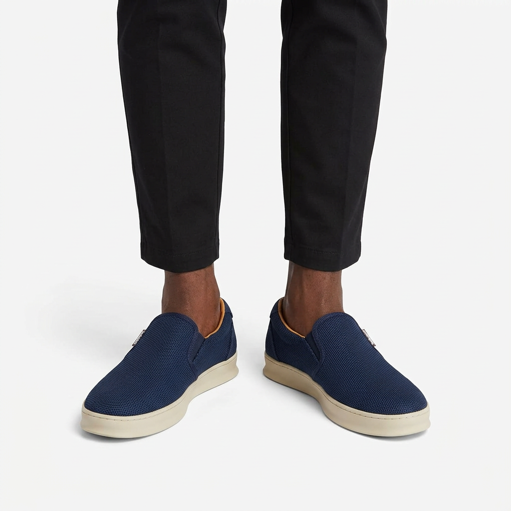 Navy textured cream-sole slip-on sneakers properly worn on both feet