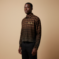 Man wearing brown crystal checkered crop shirt with black trousers