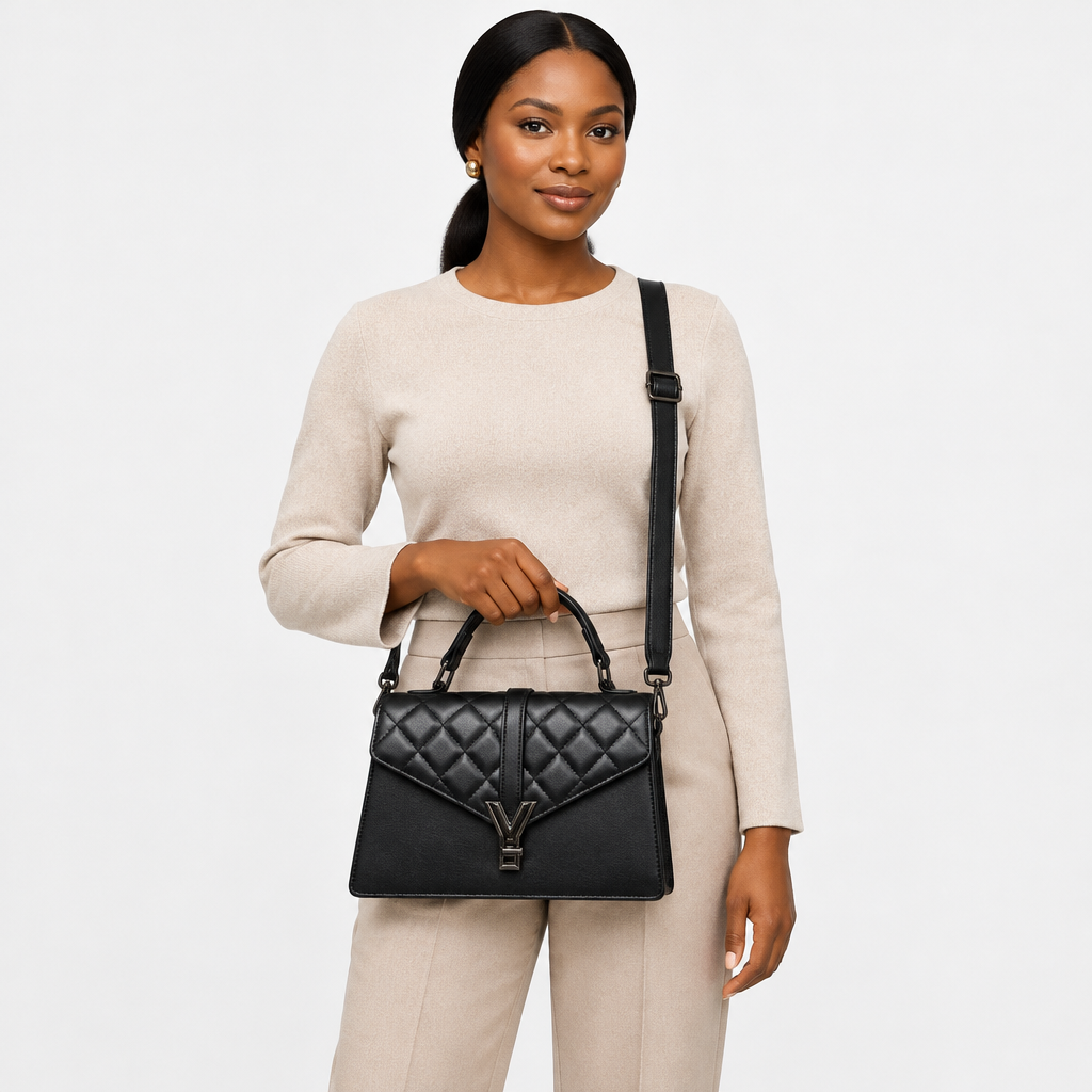 Adult woman carrying a black quilted handbag