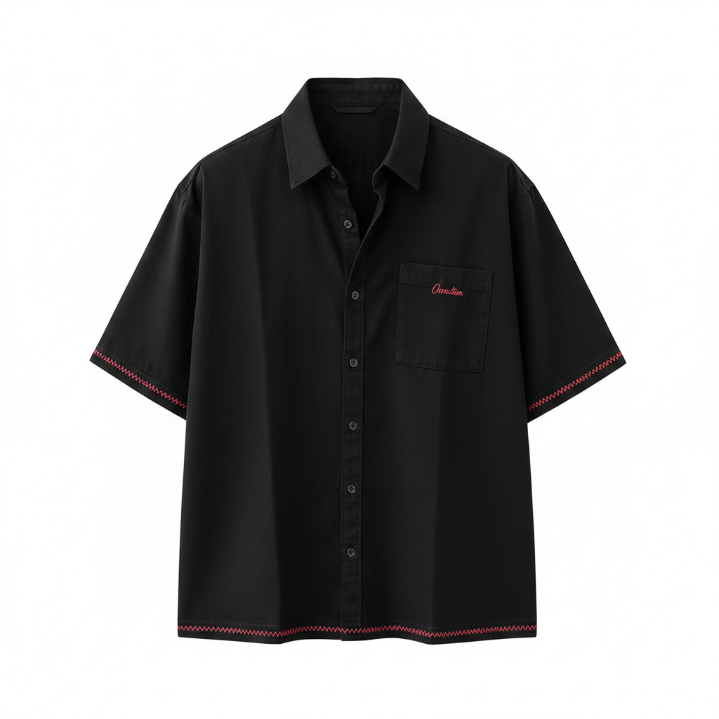 Men's black boxy short-sleeve shirt with red script embroidery and red zigzag trim, ghost mannequin front view