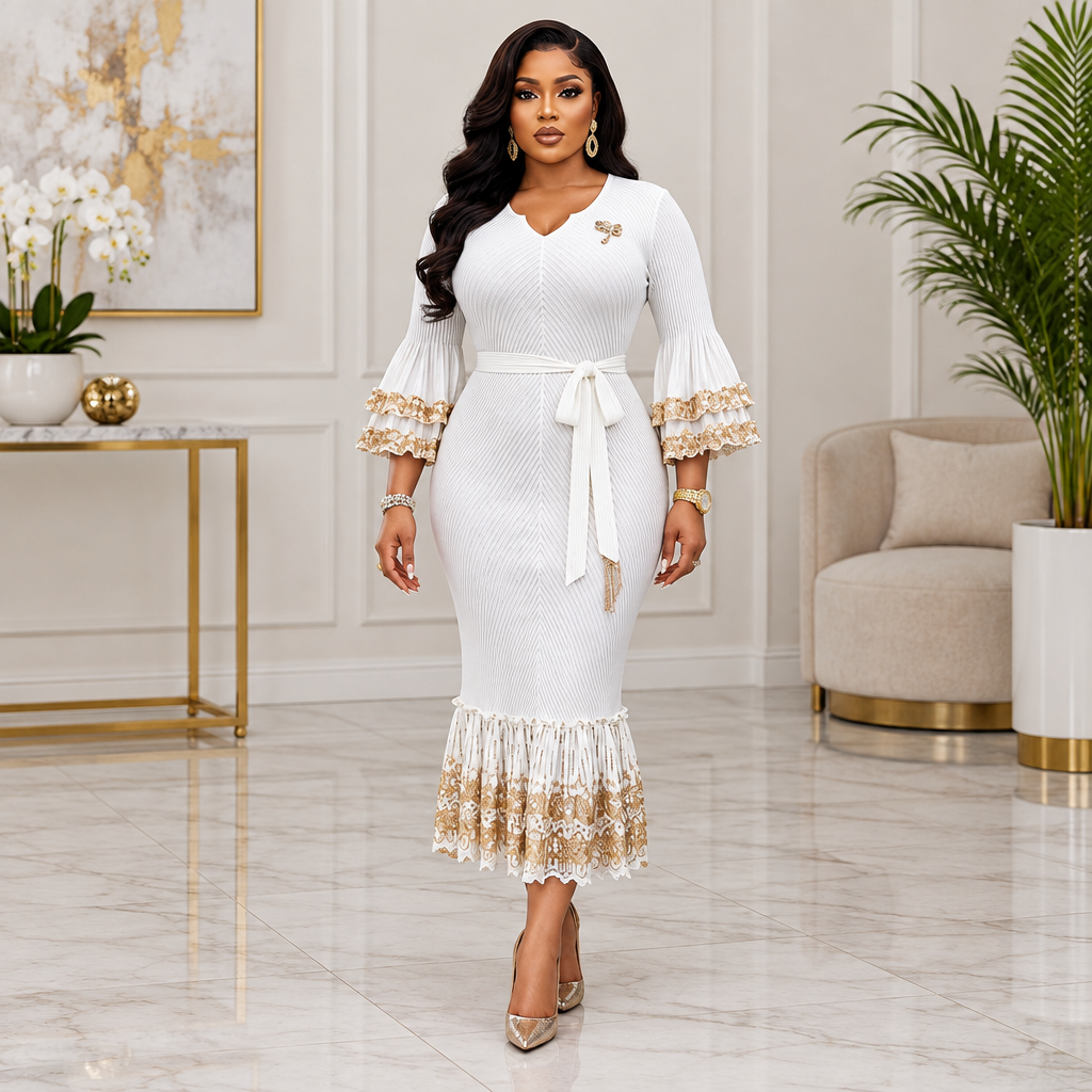 Adult Black woman wearing a white gold-trimmed bell sleeve dress
