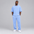 Nigerian male model wearing light blue oversized t-shirt and jogger tracksuit set