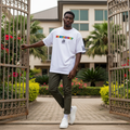 Nigerian male model wearing white oversized multicolour Northwest graphic tee in streetwear style