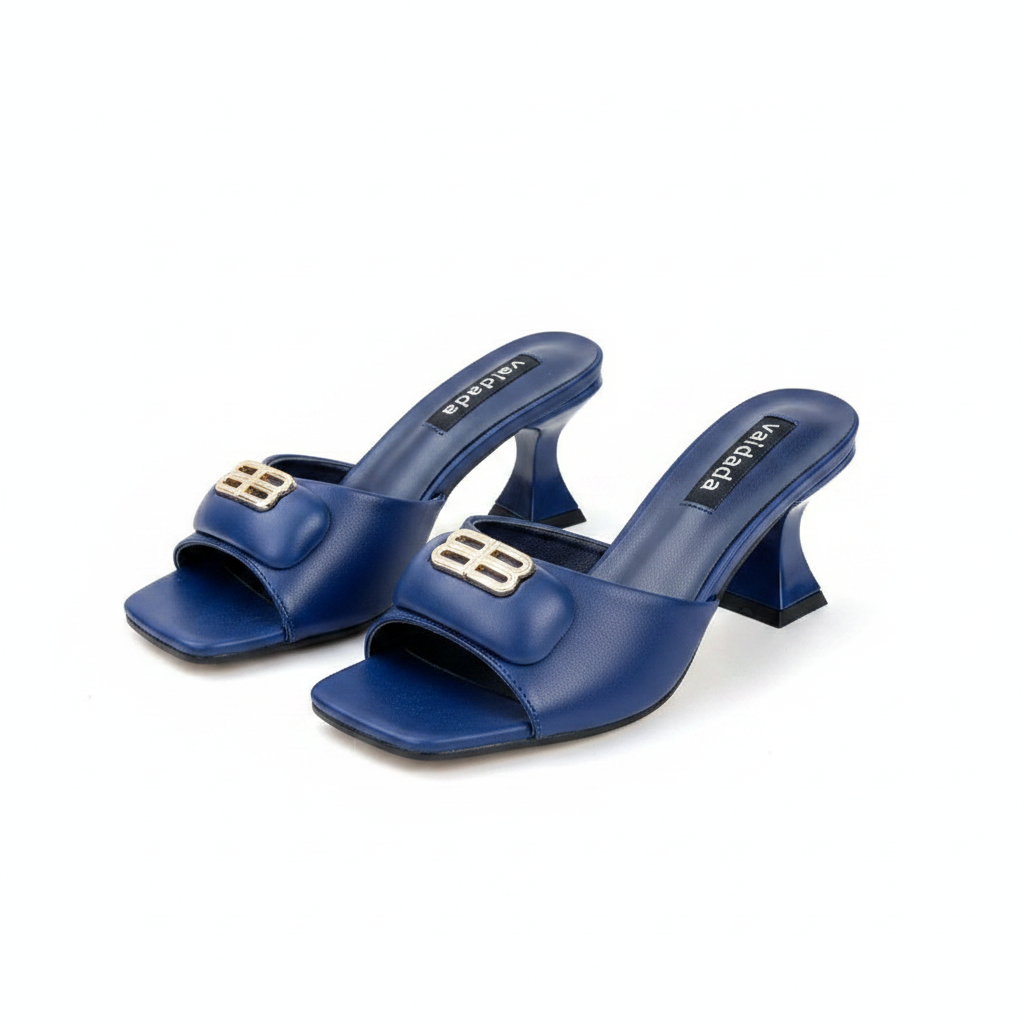 Ghost mannequin pair view of royal blue leather sculptural block heel mules with gold logo hardware