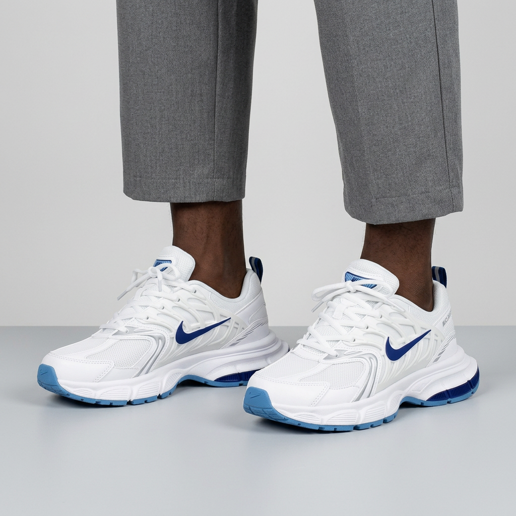 Leg-focused model wearing white and blue mesh lace-up sneakers