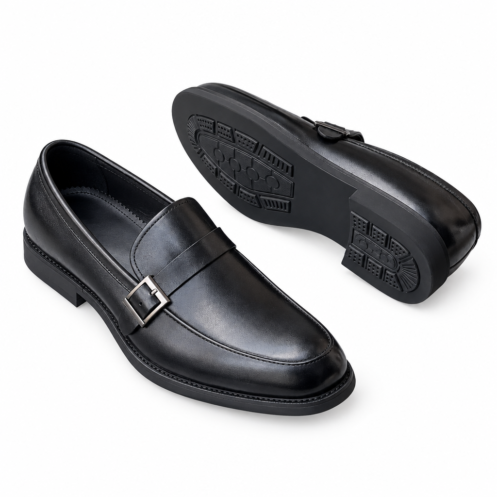 Pair of black buckle-detail loafers on white