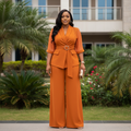 Women's 3/4-sleeve wrap-front belted wide-leg jumpsuit in orange – Nigerian female model front view