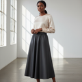 Nigerian model wearing black faux leather flared midi skirt