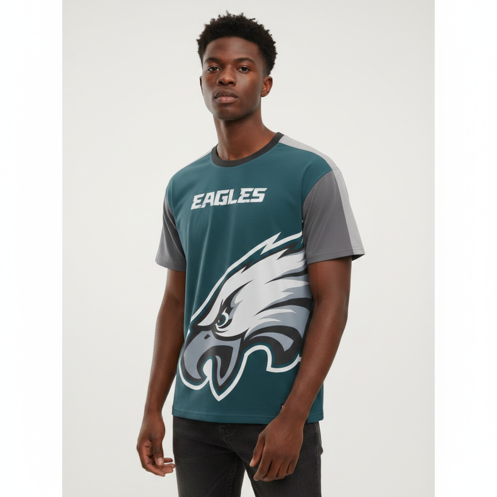 Young Nigerian male wearing dark teal Eagles oversized logo colorblock crew neck tee