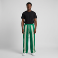 Nigerian male model wearing green striped side of reversible joggers
