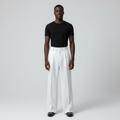 Model wearing white wide-leg palazzo trousers with a black t-shirt