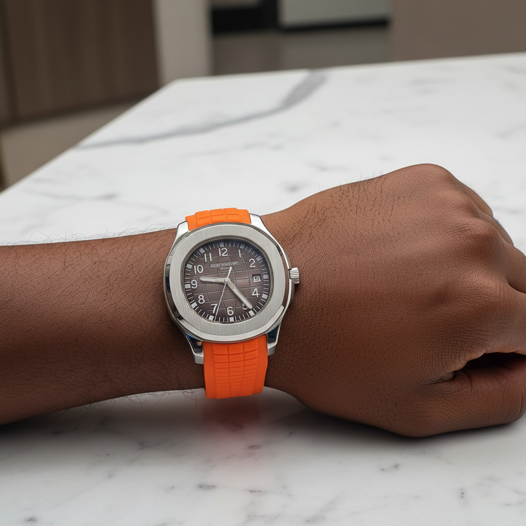 Nigerian man wrist shot wearing silver brown dial orange rubber strap luxury watch