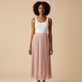 Nigerian woman wearing blush pink pearl hem pleated midi skirt - front view