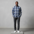 Nigerian male model wearing navy blue grey plaid long-sleeved shirt, front view