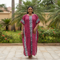 Nigerian woman wearing wine bubu dress with tribal print in garden setting