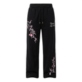 Black wide-leg drawstring trousers with pink blossom and pale branch detailing