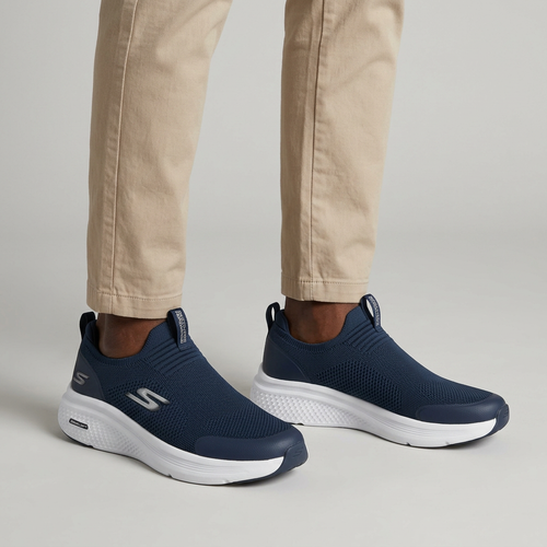 Both feet of Nigerian man wearing navy knit slip-on sneakers