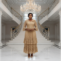 Nigerian woman wearing gold champagne lace peplum top and tiered midi skirt set