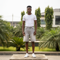 Nigerian male model wearing men's light grey silver washed wide-leg denim shorts streetwear style