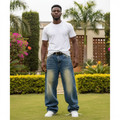Nigerian male model wearing baggy wide-leg distressed denim jeans – front view