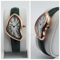 Asymmetric rose gold watch with green Roman numerals and green strap front and side view