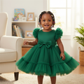 Young Nigerian baby girl wearing emerald green puff sleeve tulle dress