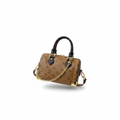 Tan monogram mini speedy bag with gold studs and red leather trim on white background