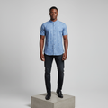 Nigerian male model wearing steel blue ditsy floral print short-sleeved shirt