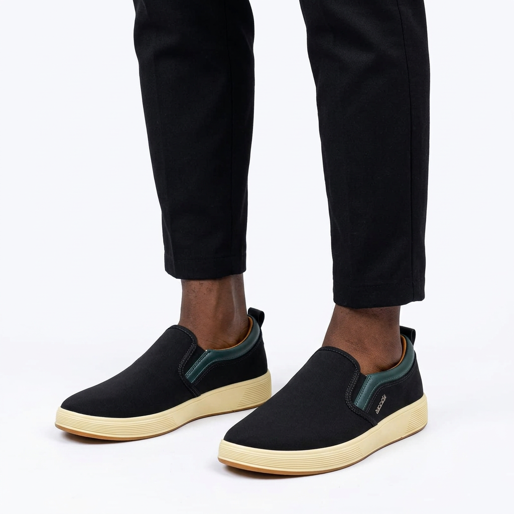 Black green-trim cream-sole sneakers properly worn on both feet