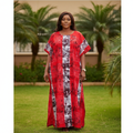 Nigerian woman wearing red bubu dress with tribal print in garden setting