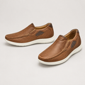 Pair of men's brown slip-on loafers with dark side panels and light soles