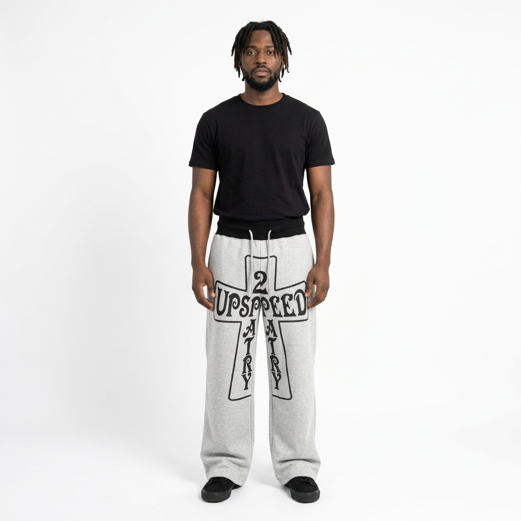 Full-body male model wearing light-grey cross-graphic trousers