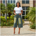 Nigerian female model wearing dark teal rhinestone wide leg cropped denim jeans in garden setting