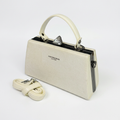 Ivory structured top-handle handbag with matching detachable strap on a white background