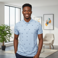 Young Nigerian male model wearing sky blue all-over bird print polo shirt, front view