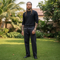 Nigerian male model wearing dark charcoal baggy straight-leg gothic embroidery panel seam denim jeans
