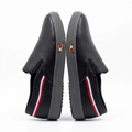 Pair of black perforated contrast-trim slip-on shoes on white background