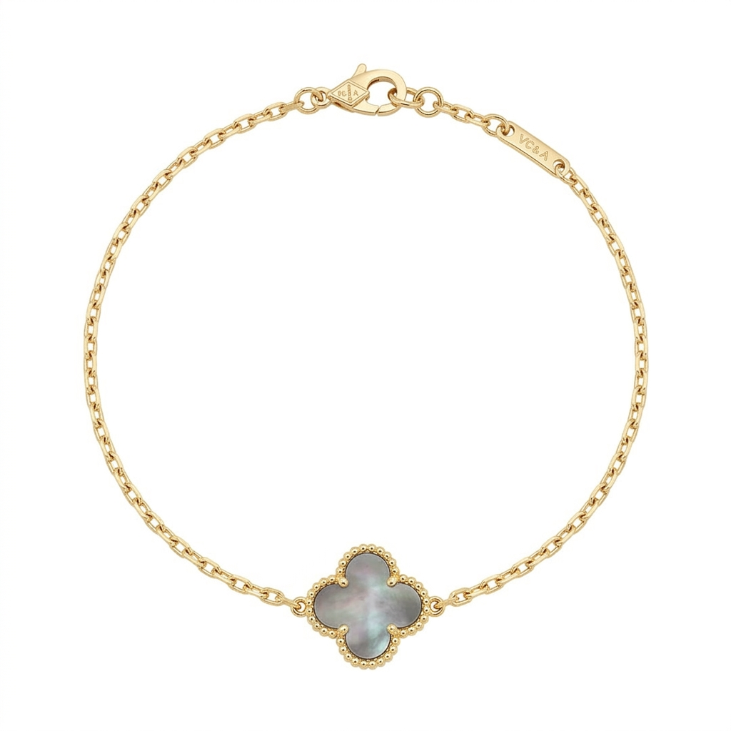 Gold-tone chain bracelet with a single grey iridescent clover