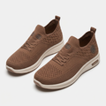 Pair of brown knit lace-up sneakers on white