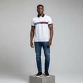 Nigerian male model wearing white navy-trim chest stripe polo shirt, front view