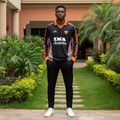 Black and orange patterned sleeve long-sleeve retro football jersey — Nigerian male model front view