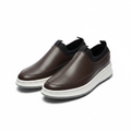 Pair of brown leather slip-on sneakers with white midsole on a white background