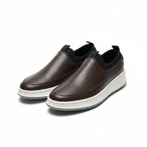Pair of brown leather slip-on sneakers with white midsole on a white background