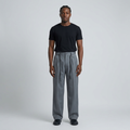Full-body male model wearing grey cord-detail wide-leg trousers