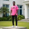 Nigerian male model wearing men's hot pink graphic short-sleeve tee full body streetwear editorial shot