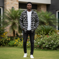 Young Nigerian male wearing black and white plaid flannel long sleeve shirt